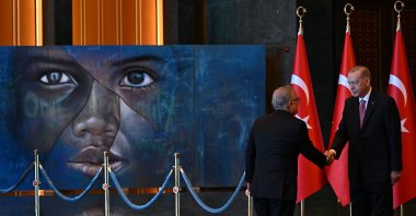 President Recep Tayyip Erdoğan received congratulations in front of the “Refugee Kid”-themed painting, drawn specially for 2016's World Humanitarian Summit, Ankara, Türkiye, Aug. 30, 2023. (AA Photo)