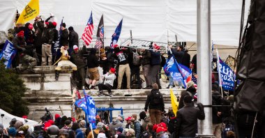 A group of pro-Trump protesters climb the walls of the Capitol Building after storming the West lawn, Washington, DC, Jan. 6, 2021. (Getty Images Photo)