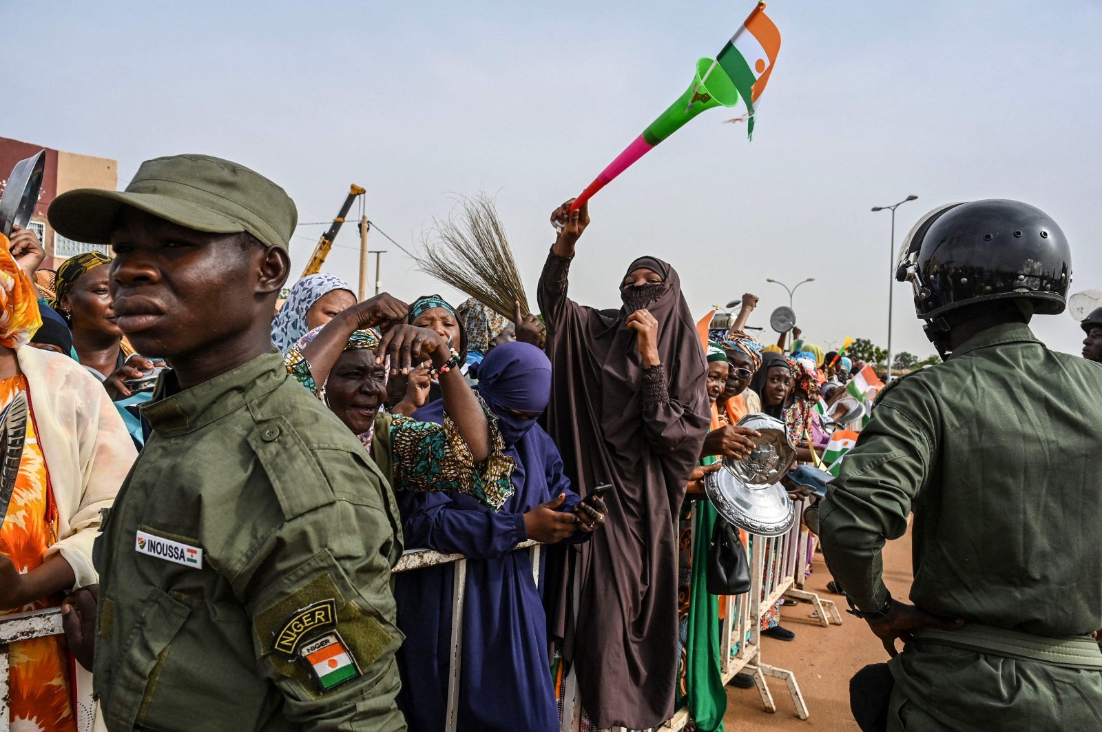 Nigerien Police officers stand guard as supporters of Niger&#039;s National Council of Safeguard of the Homeland (CNSP) protest outside the Niger and French airbase, Niamey, Niger, Aug. 30, 2023. (AFP Photo)