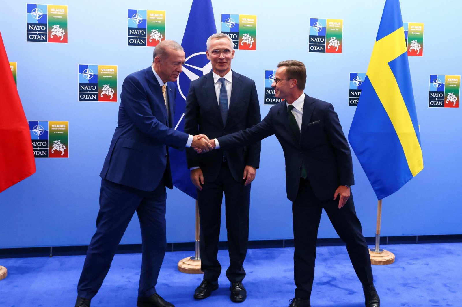 President Tayyip Erdoğan and Swedish Prime Minister Ulf Kristersson (R) shake hands next to NATO Secretary-General Jens Stoltenberg (C) prior to their meeting, on the eve of a NATO summit, in Vilnius, Lithuania, July 10, 2023. (Reuters Photo)