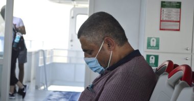 A citizen is seen asleep on a ferry in Istanbul, Türkiye, June 15, 2020. (Shutterstock Photo)