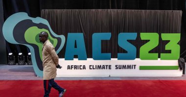 A worker walks past an Africa Climate Summit logo during preparations ahead of the Africa Climate Summit 2023 at the Kenyatta International Convention Centre in Nairobi, Kenya, Sept. 2, 2023. (AFP Photo)