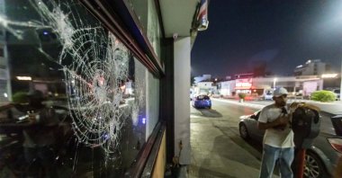 The front glass of the store is seen shattered, as protesters attacked the hair salon that belongs to a migrant, Limassol, Greek Cypriot administration, Sep. 2, 2023. (Rueters Photo)