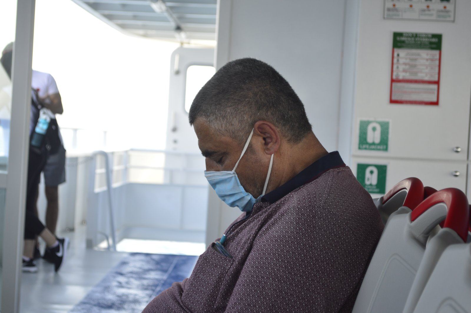 A citizen is seen asleep on a ferry in Istanbul, Türkiye, June 15, 2020. (Shutterstock Photo)