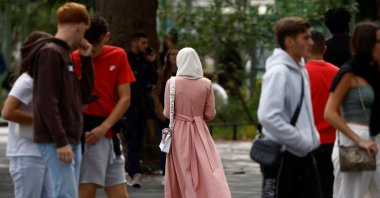 A Muslim woman, wearing the style of dress called an abaya, walks in a street in Nantes, France, August 29, 2023. REUTERS/Stephane Mahe