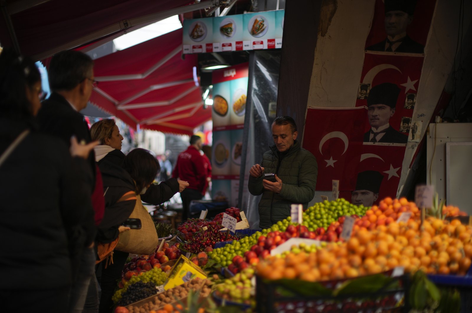 People are seen in a food market in the Beşiktaş neighborhood, Istanbul, Türkiye, May 18, 2023. (AP Photo)