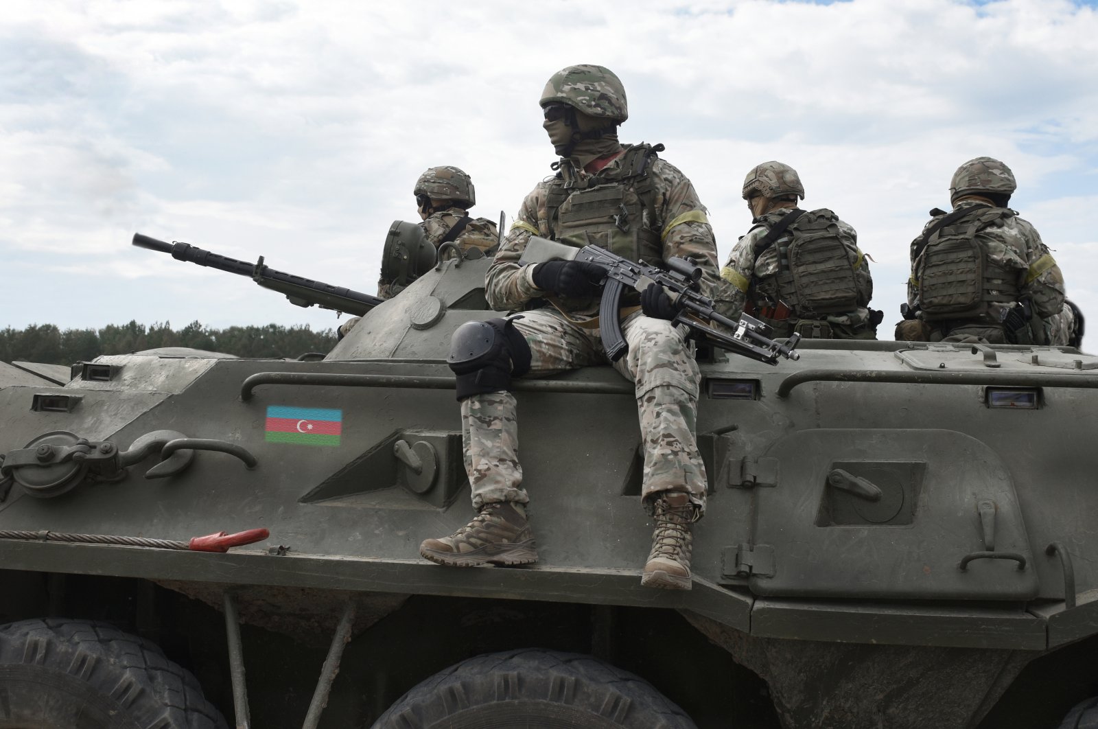 Flag of Azerbaijan on an armored personnel carrier and soldiers with machine guns in this undated file photo. (Shutterstock File Photo)