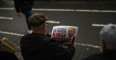A man reads an election handout of President Recep Tayyip Erdoğan in Istanbul, Türkiye, May 23, 2023. (AP Photo)