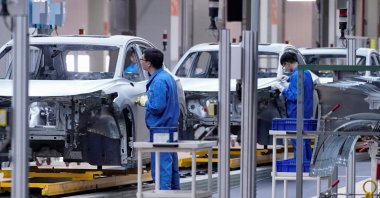 Employees work on the assembly line during a construction completion event of the SAIC Volkswagen MEB electric vehicle plant in Shanghai, China, Nov. 8, 2019. (Reuters Photo)