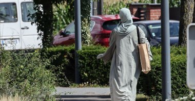 A woman wearing an abaya walks through the streets of Lille, northern France, Aug. 28, 2023. (AFP Photo)