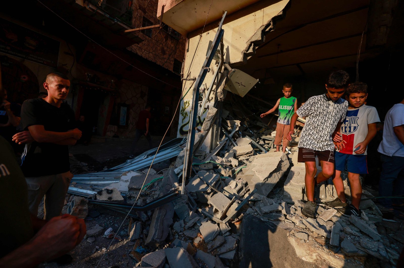 Children walk on the rubble of a building at the Nur Shams refugee camp in Tulkarm, occupied West Bank, Palestine, Sept. 5, 2023. (AFP Photo)