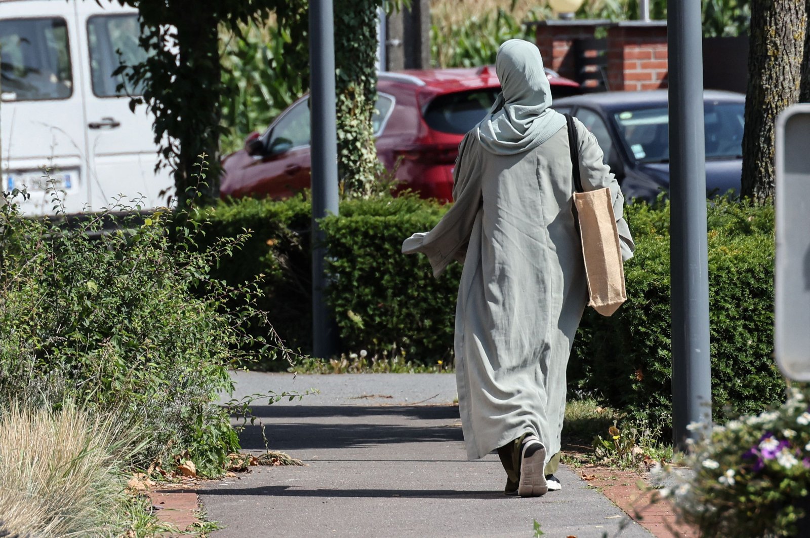 A woman wearing an abaya walks through the streets of Lille, northern France, Aug. 28, 2023. (AFP Photo)