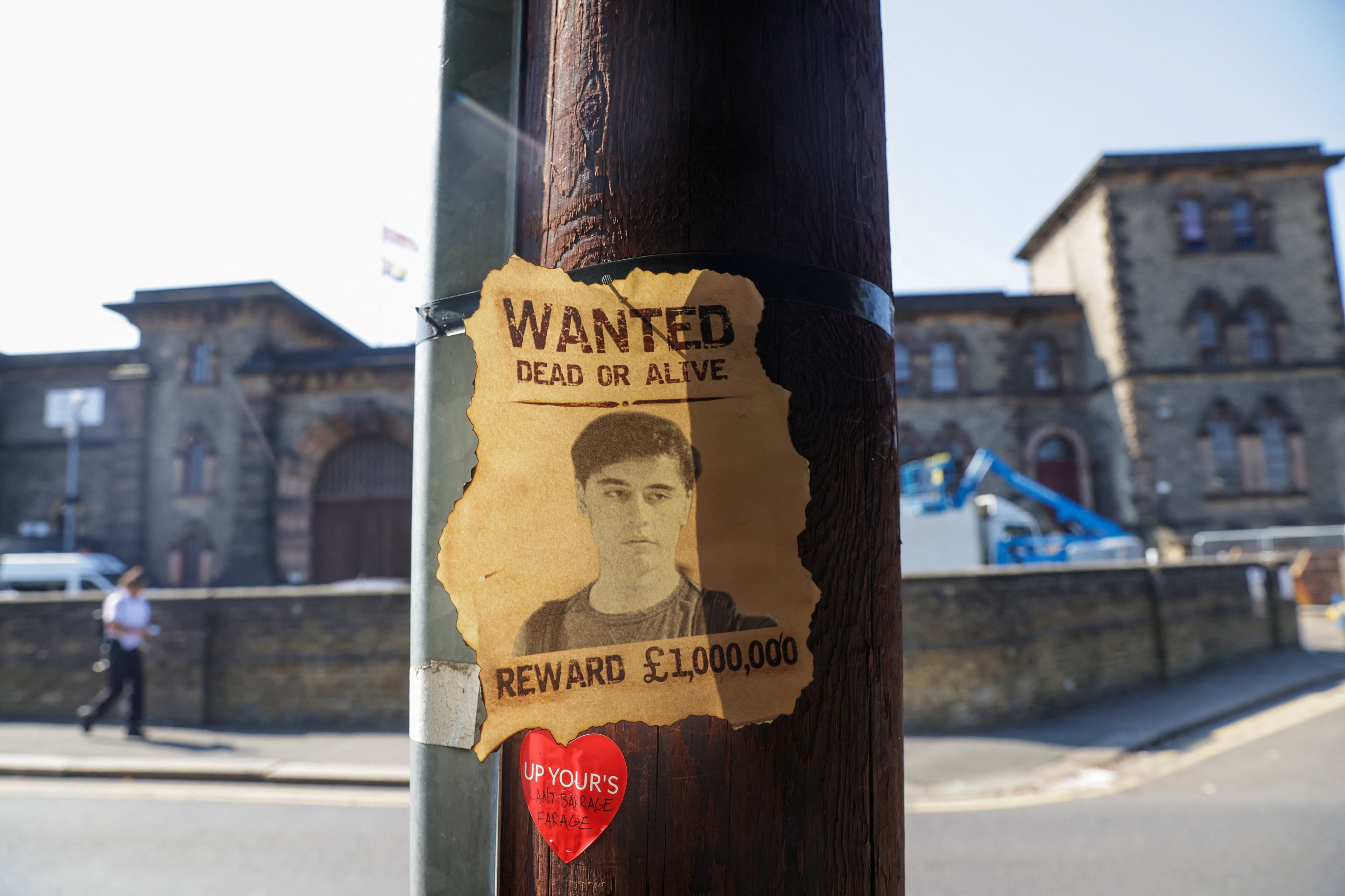 A wanted sign featuring an image of Daniel Abed Khalife, a former soldier who is suspected of terrorism offences, is displayed, near Wandsworth prison which he escaped from, in London, Britain, Sept. 7, 2023. (Reuters Photo)