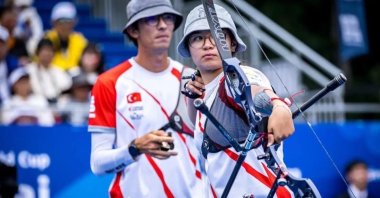 Fatma Maraşlı (R) shoots an arrow in from of Mete Gazoz during the Archery World Cup, Shanghai, China, Aug. 14, 2023. (IHA Photo)