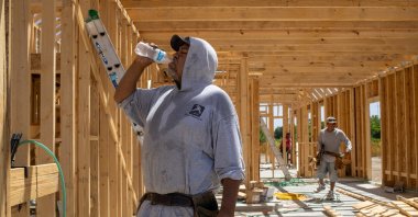 Jesus Picasso, a builder originally from Mexico, takes a water break during hot weather in Manvel, Texas, U.S., July 13, 2023. (Reuters Photo)