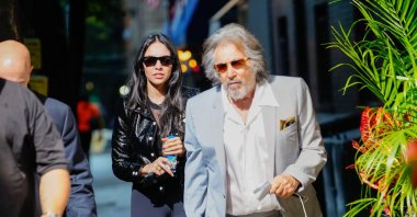 Noor Alfallah and Al Pacino arrive for a music video shoot with Bad Bunny, New York, U.S., Aug. 24, 2023. (Getty Images Photo)