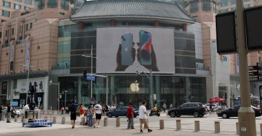 Surveillance cameras are seen near an iPhone advertisement at an Apple store in Beijing, China, Sept. 7, 2023. (Reuters Photo)