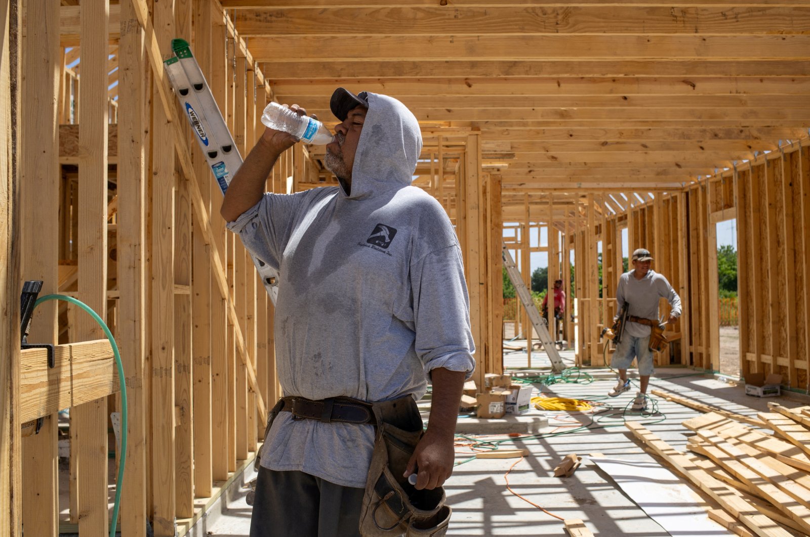 Jesus Picasso, a builder originally from Mexico, takes a water break during hot weather in Manvel, Texas, U.S., July 13, 2023. (Reuters Photo)