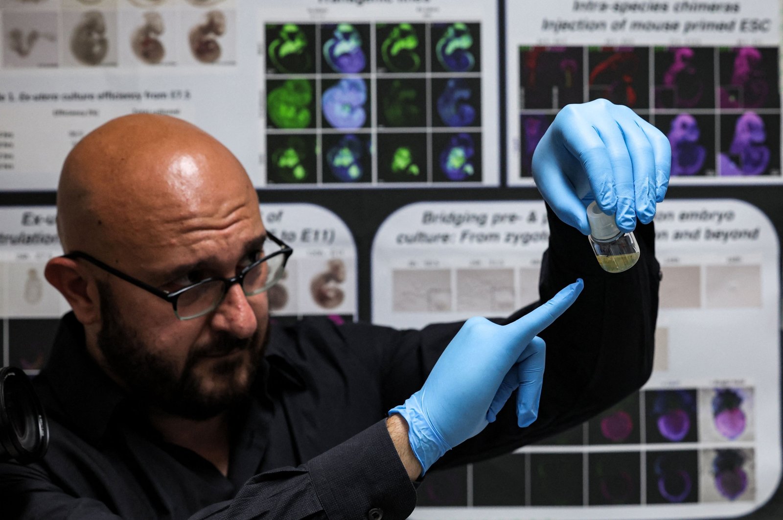 Dr. Jacob Hanna, a specialist in molecular genetics at Israel&#039;s Weizmann Institute of Science, holds a vial containing five-day-old synthetic mouse embryos grown in an electronically controlled ex-utero roller culture platform, Rehovot, Israel, Aug. 04, 2022. (AFP Photo)