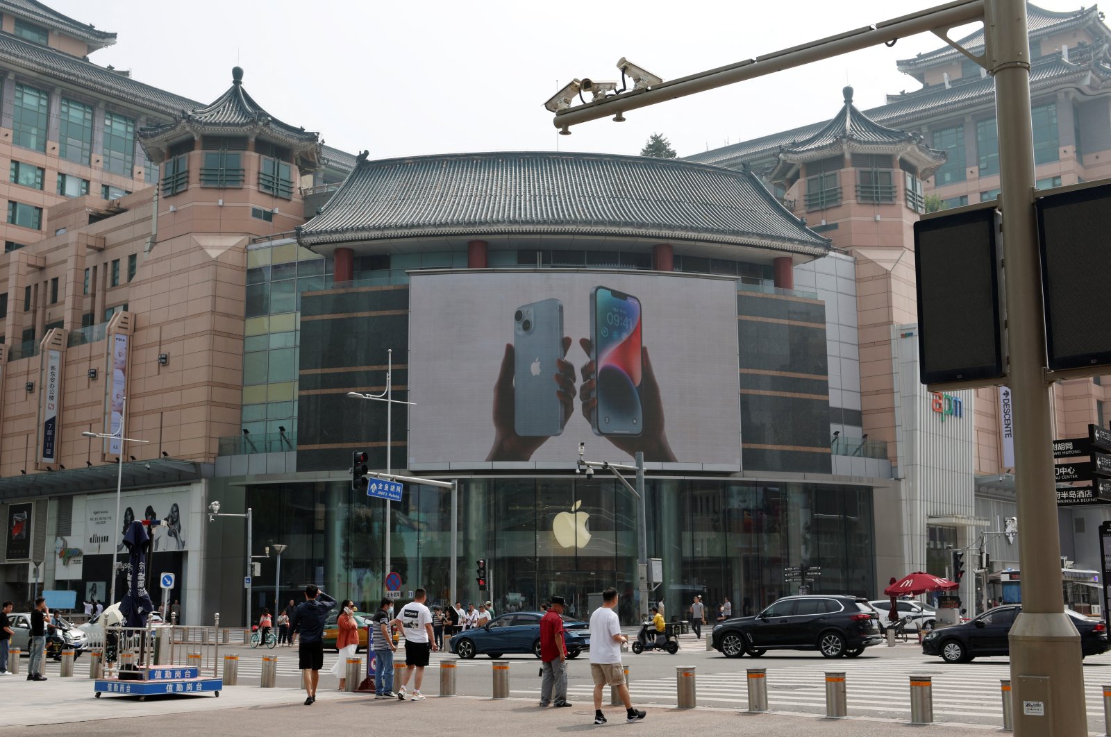 Surveillance cameras are seen near an iPhone advertisement at an Apple store in Beijing, China, Sept. 7, 2023. (Reuters Photo)