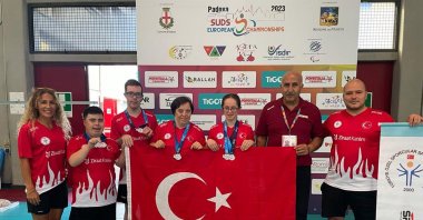 Turkish athletes with Down syndrome team poses with the national flag after clinching medals at the European Championships, Padova, Italy, Sept. 6, 2023. (AA Photo)