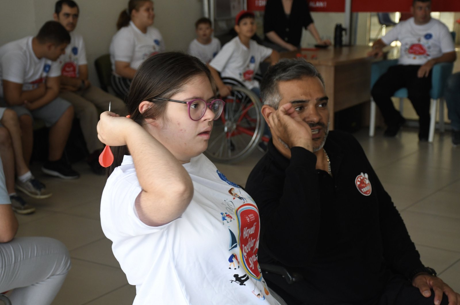 Turkish former wheelchair athlete teaches a youngster with Down syndrome to throw darts, Bursa, Türkiye, Sept. 5, 2023. (AA Photo)