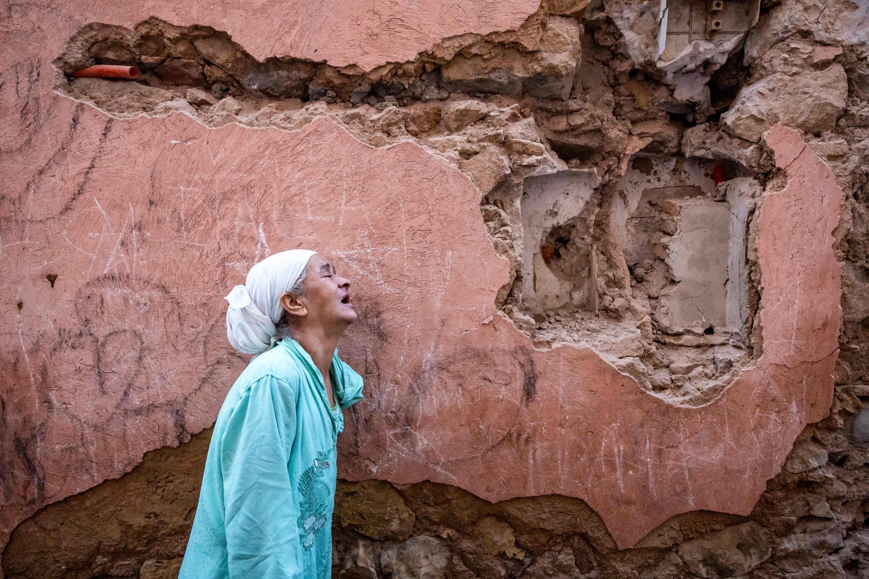 A woman reacts standing infront of her earthquake-damaged house in the old city in Marrakech, Morocco, Sept. 9, 2023. (AFP Photo)