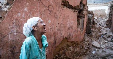 A woman reacts standing in front of her earthquake-damaged house in the old city in Marrakesh on Sept. 9, 2023. (AFP Photo)