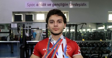 Turkish para-arm wrestler Ismail Hacı Bekar shows off his medals at the Kağıtspor Club, Kocaeli, Türkiye, Sept. 10, 2023. (AA Photo)