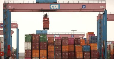A crane lifts a shipping container at the HHLA Container Terminal Altenwerder on the River Elbe in Hamburg, Germany, March 31, 2023. (Reuters Photo)
