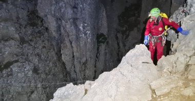 Members of the National Alpine Cliff and Cave Rescue Corps (CNSAS) start to descend on ropes into Morca Cave during a rescue operation near Anamur, southern Türkiye, Sept. 11, 2023. (AP Photo)