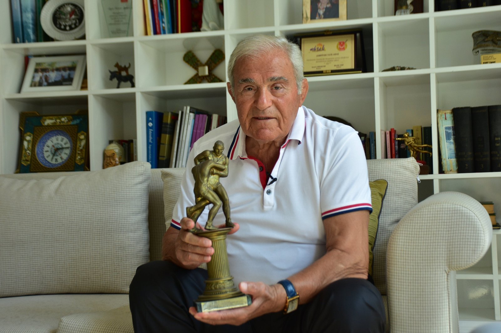 Turkish Wrestling Foundation co-founder and former athlete Ahmet Ayık poses with a trophy at his Champion Holiday Village in Kemer, Antalya, Türkiye, Sept. 8, 2023. (AA Photo)