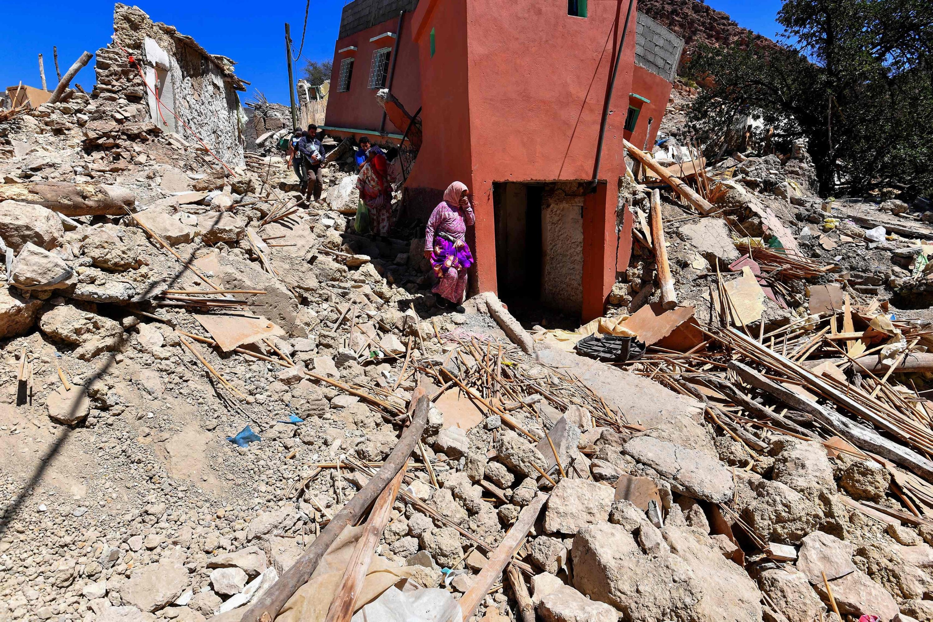 Women react as they walk on the rubble of Imoulas village in the Taroudant province, Morocco, Sept. 11, 2023. (AFP Photo)