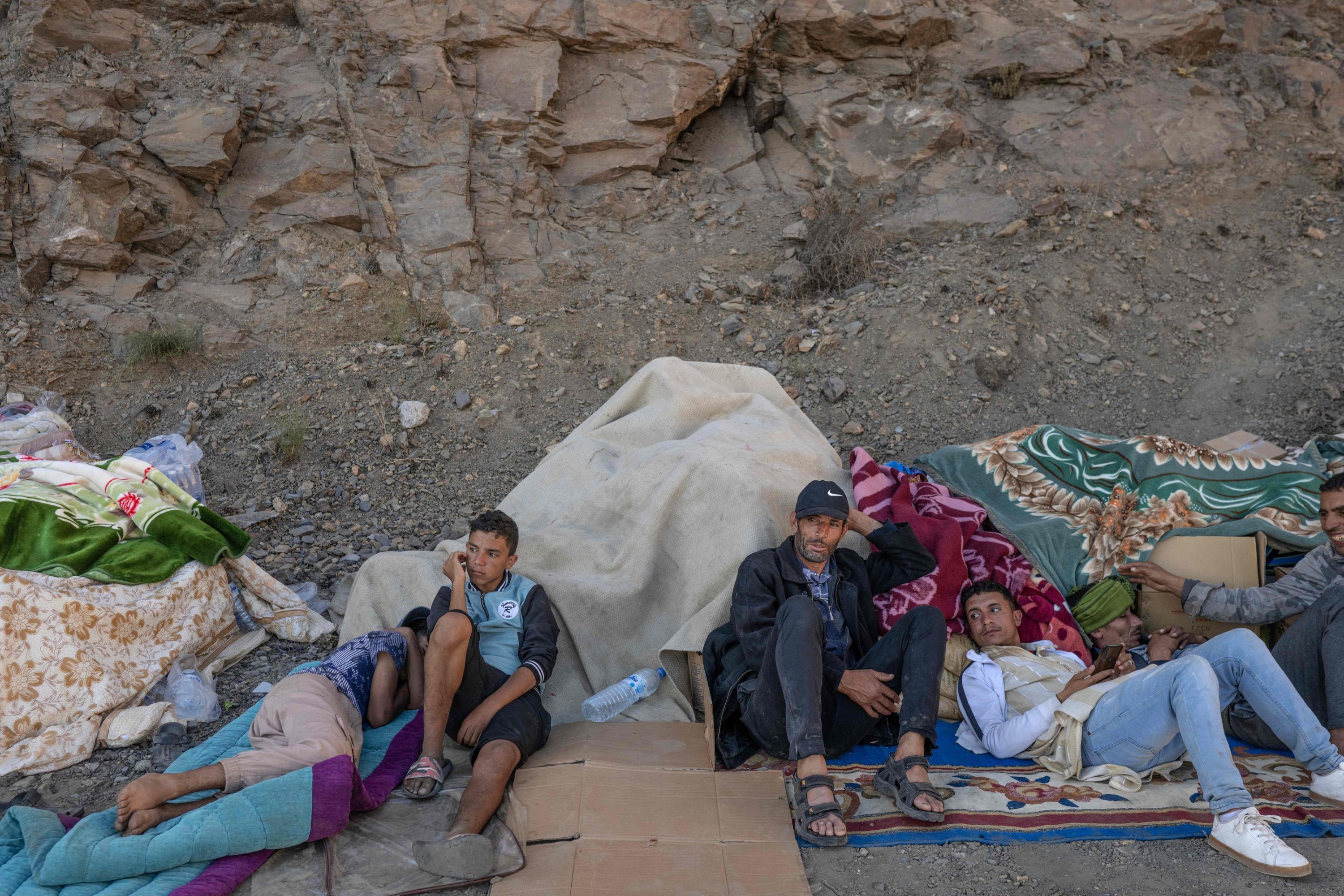 People wait as emergency personnel open a road to their village in the mountainous area of Tizi N'Test, in the Taroudant province, Morocco, Sept. 11, 2023. (AFP Photo)