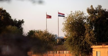 Syrian and Turkish flags flutter at the Turkish-Syrian border, as seen from the northeastern Syrian city of Qamishli, Syria, Sept. 9, 2022. (Reuters Photo)