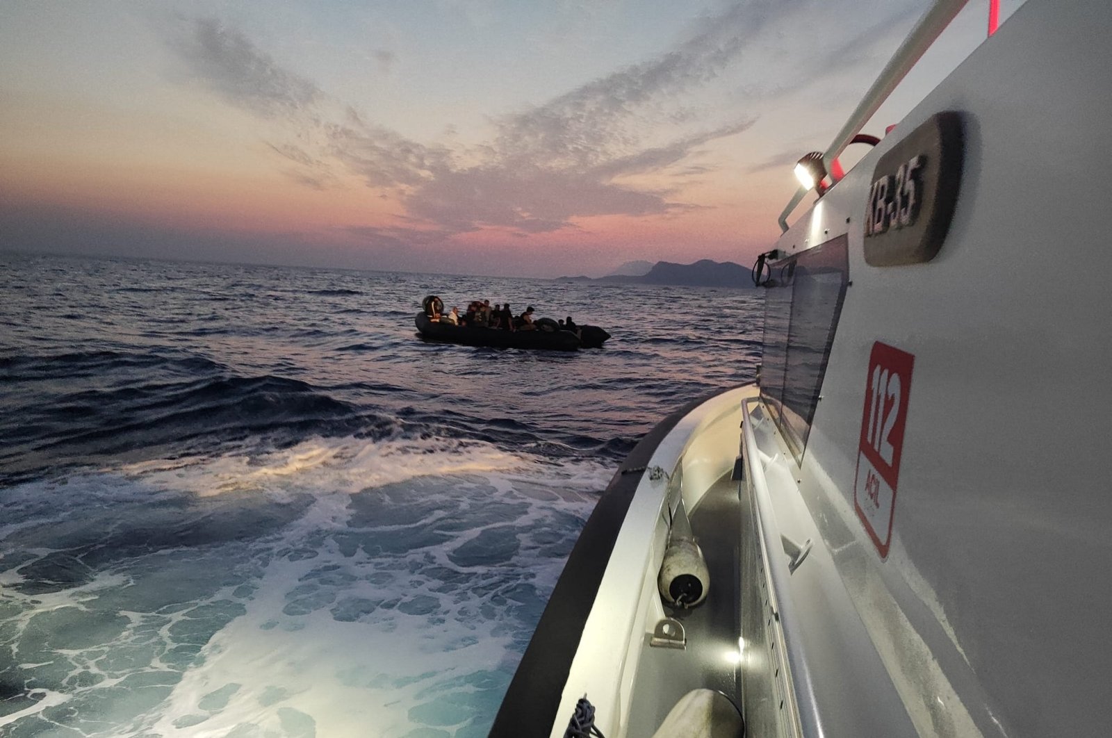 A Turkish coast guard boat comes to the rescue of 61 irregular migrants on a life raft off the coast of western Muğla province, Türkiye, Sept. 11, 2023. (AA Photo)