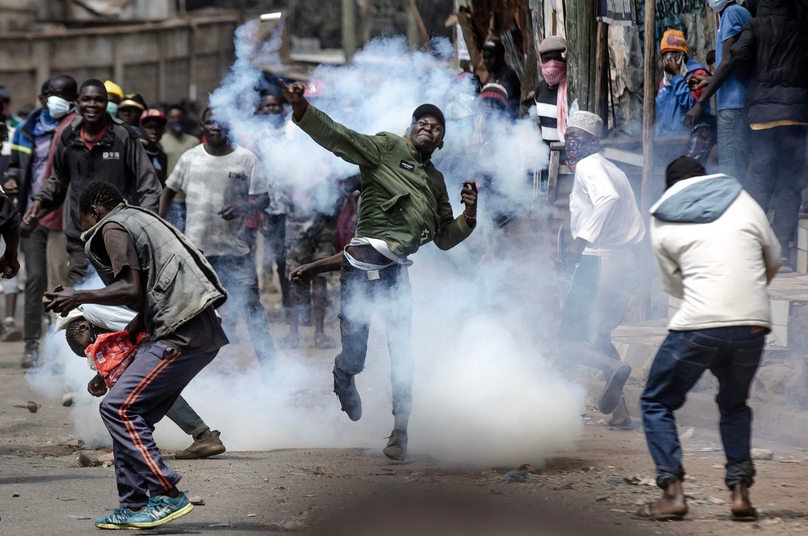 An opposition supporter throws a tear gas canister fired by anti-riot police during clashes with Kenya police officers during anti-government protests, Nairobi, Kenya, July 21, 2023. (AFP Photo)