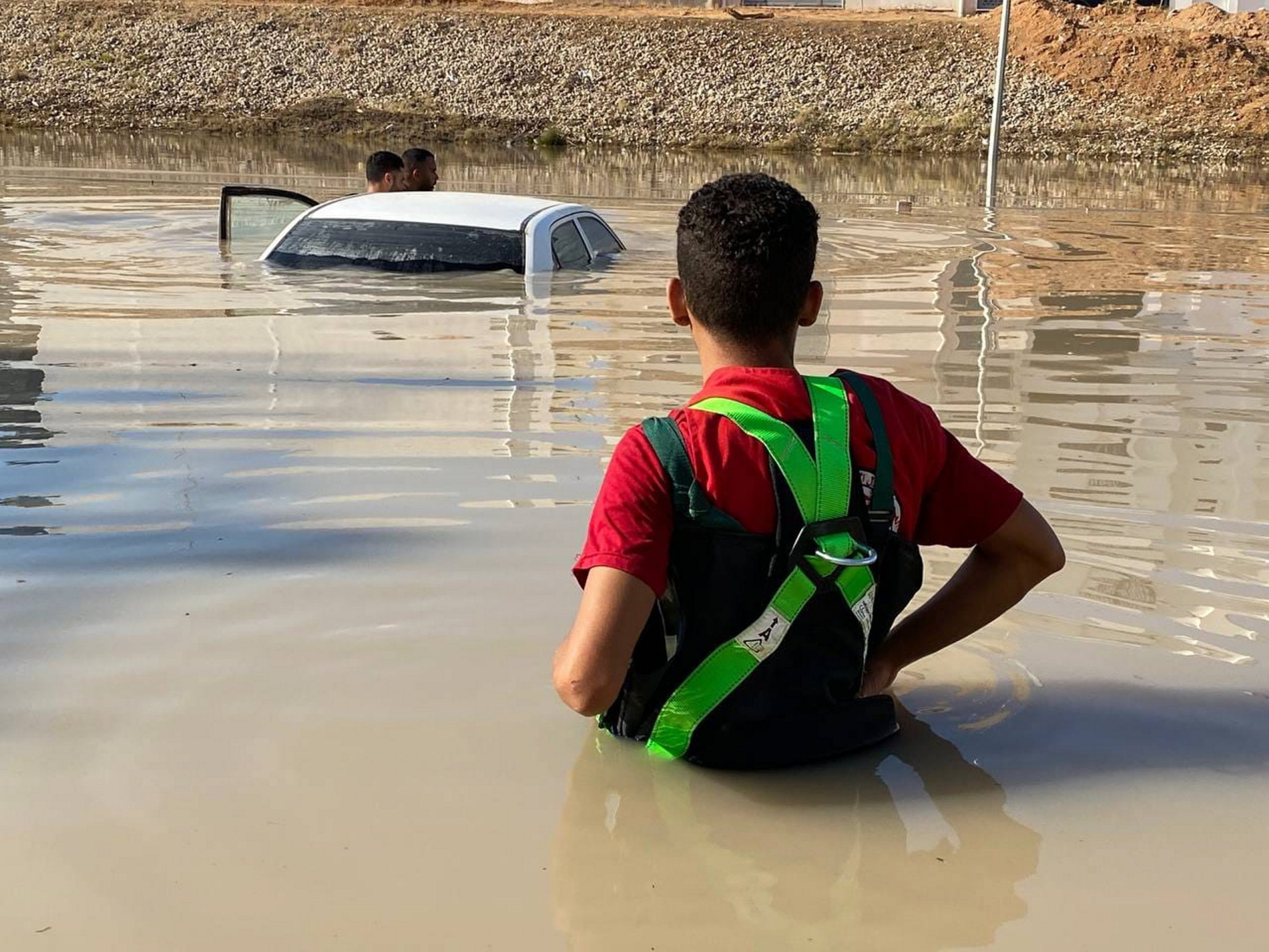 A Libyan Red Crescent member inspects vehicles in the floods at an undefined location in eastern Libya, Sept. 11, 2023. (EPA Photo)