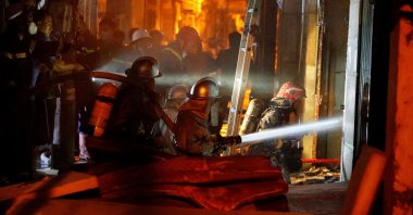 Firefighters work to put out a fire and rescue people at an apartment block in Hanoi, Vietnam, Sept. 13, 2023. (AFP Photo)