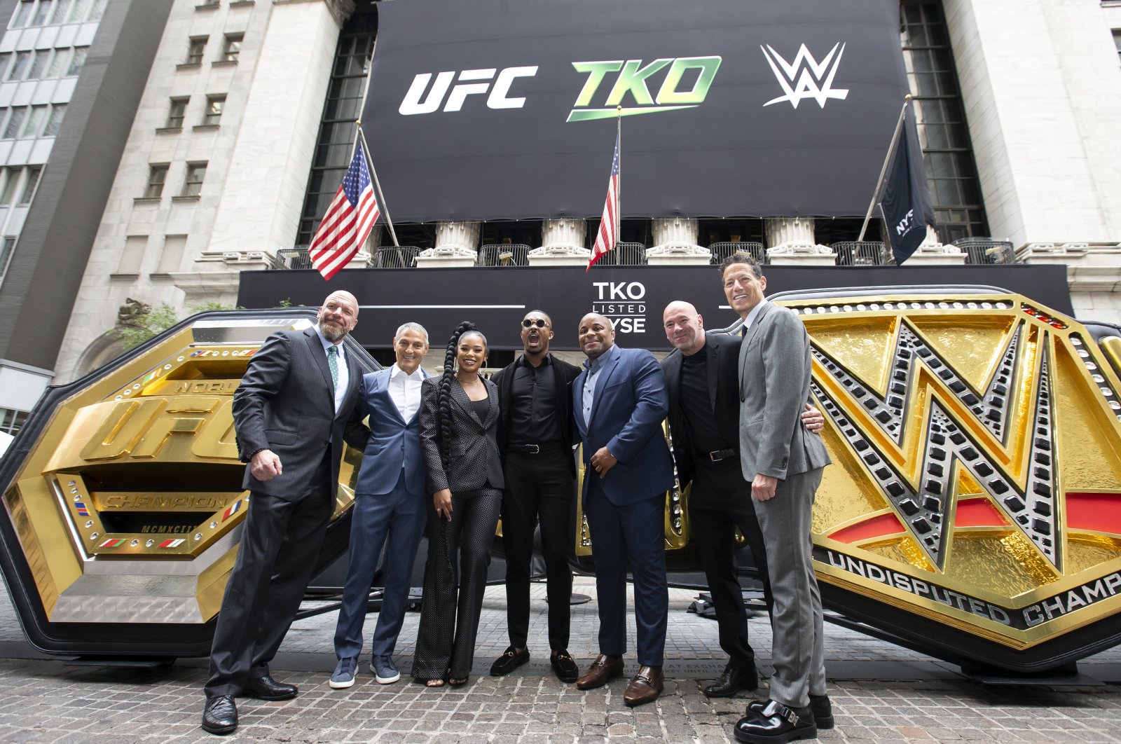 (L-R) WWE Chief Content Officer Paul Levesque (Triple H), TKO   Endeavor CEO Ariel Emanuel, WWE Superstars Bianca Belair and Montez Ford, UFC hall of famer Daniel Cormier, UFC CEO Dana White, and TKO   Endeavor President and COO Mark Shapiro pose outside the New York Stock Exchange during the TKO Group Holdings&#039; listing, New York, US., Sept. 12, 2023. (Getty Images Photo)