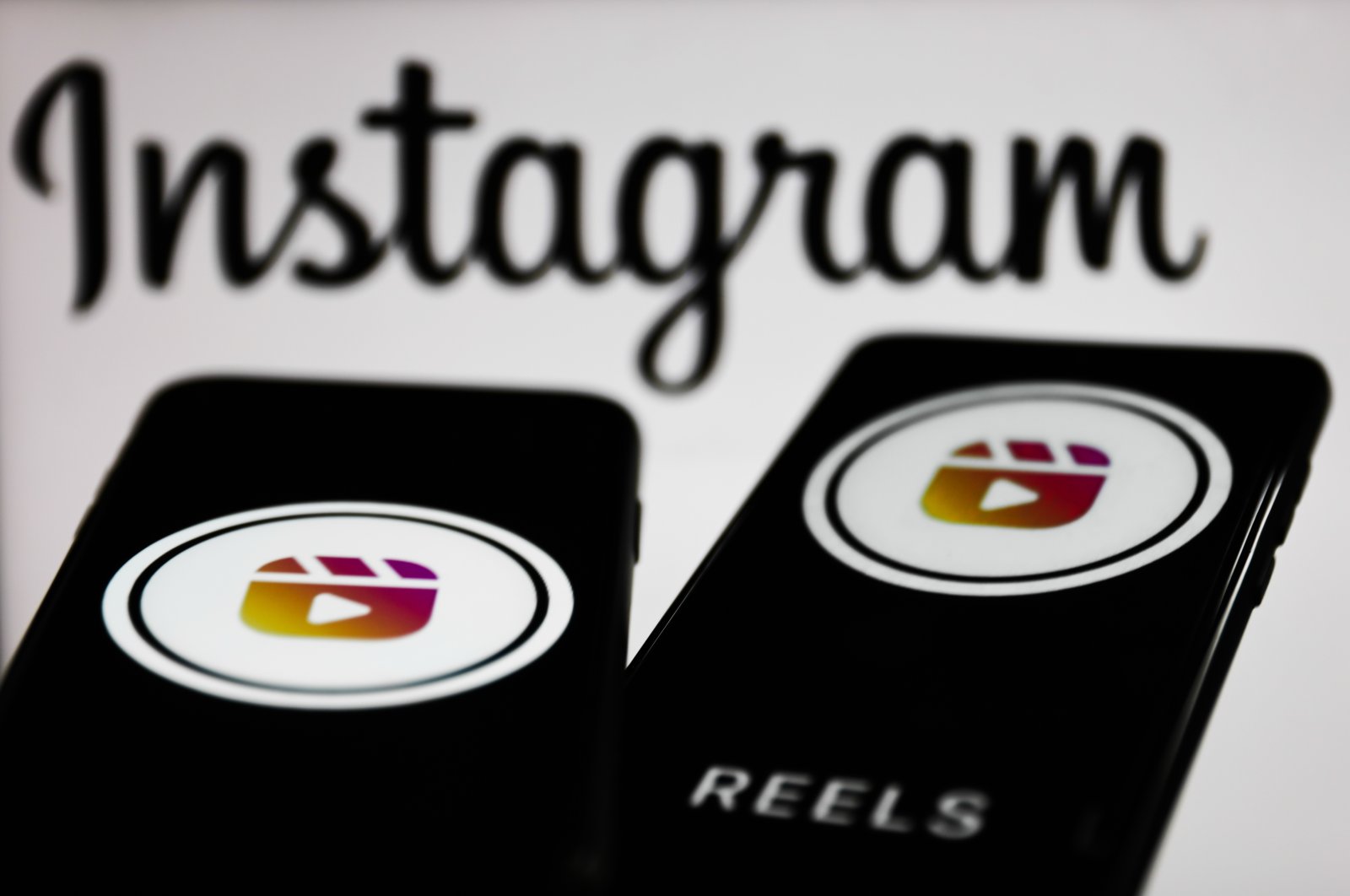 Instagram Reels logos displayed on smartphone screens in front of an Instagram logo in this illustration photo taken in Krakow, Poland, Nov. 2, 2021. (Getty Images Illustration)