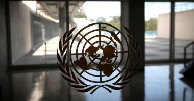 The United Nations logo is seen on a window in an empty hallway at U.N. headquarters during the 75th annual U.N. General Assembly high-level debate, Sept. 21, 2020. (Reuters Photo)