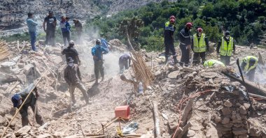 Rescuers and villagers sift through the rubble of a destroyed building in a village near Amizmiz, central Morocco, Sept. 13, 2023. (AFP Photo)