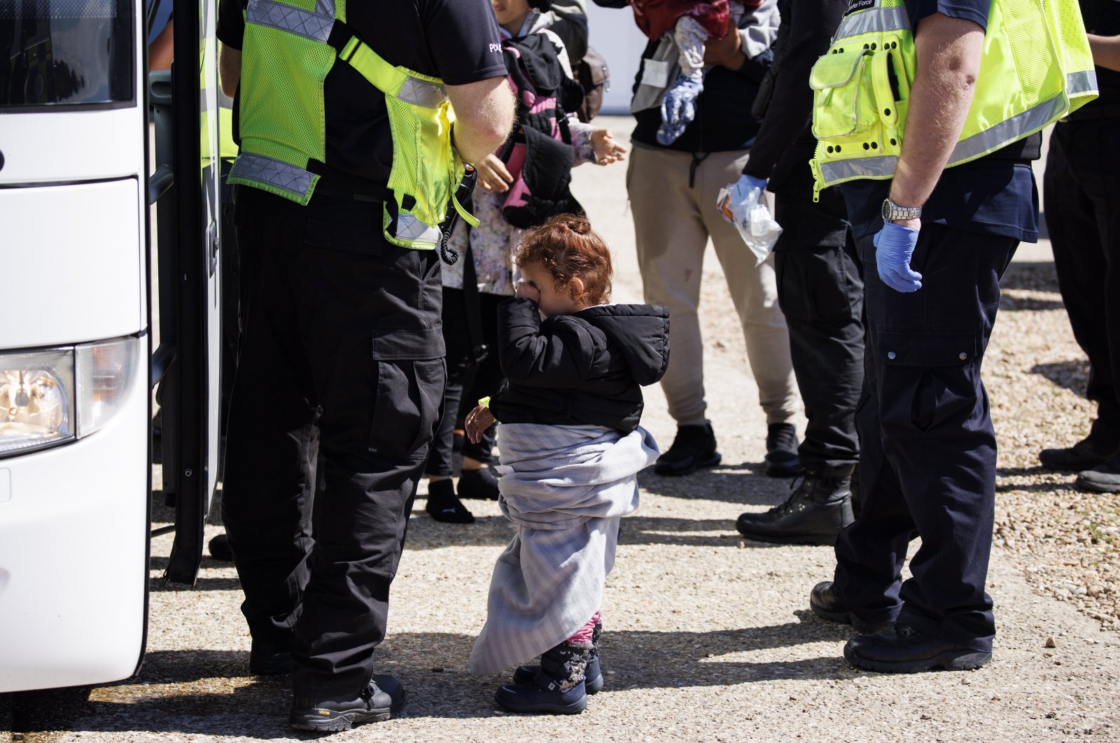 A child rescued from a boat crossing the English Channel is taken to a Home Office bus in Kent, U.K., Aug. 21, 2023. (EPA Photo)