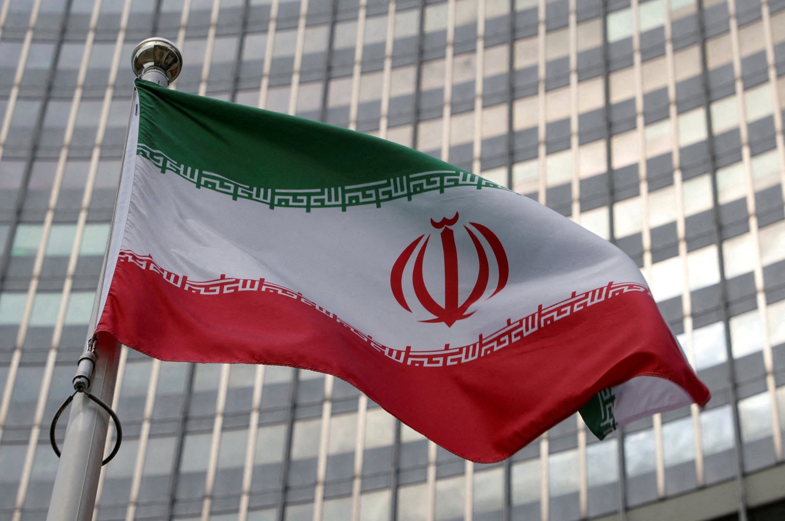 The Iranian flag flutters in front of the International Atomic Energy Agency (IAEA) organisation&#039;s headquarters in Vienna, Austria, June 5, 2023. (Reuters Photo)