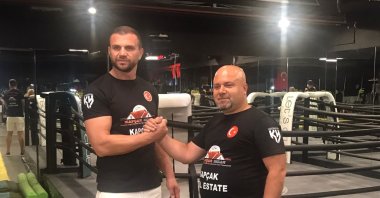 Turkish kickboxer Kadir Yıldırım (L) poses for a photo with his sponsor Sedat Kapçak, Istanbul, Türkiye, Sept. 15, 2023. (IHA Photo)