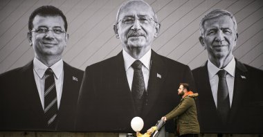 A man walks past a billboard of Republican People's Party (CHP) Chair Kemal Kılıçdaroğlu (C), Istanbul Mayor Ekrem Imamoglu (L) and Ankara Mayor Mansur Yavaş, Istanbul, Türkiye, May 6, 2023. (AP Photo)
