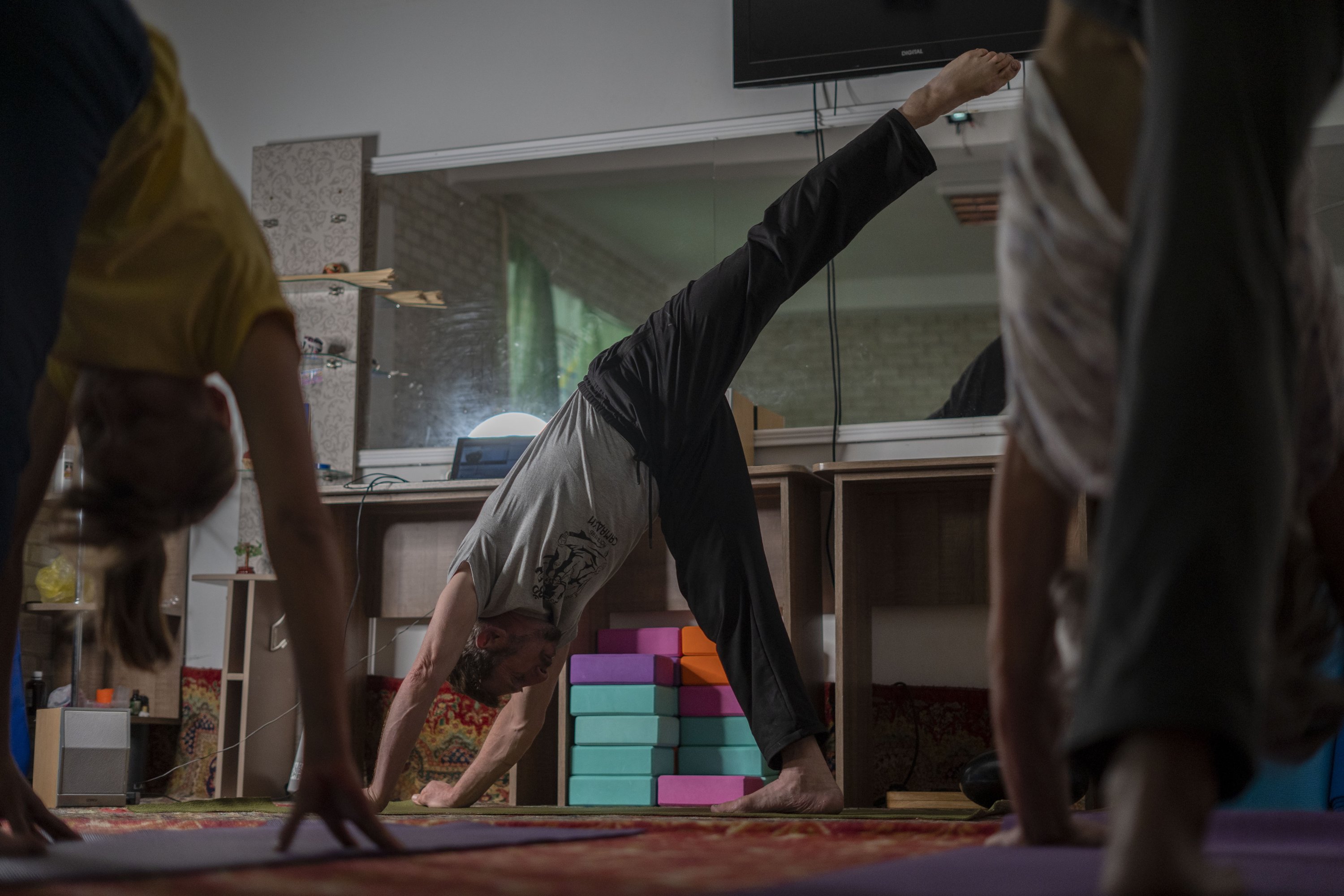 Serhii Zaloznyi, center, a 52-year-old yoga instructor, holds a yoga session in a basement in Kramatorsk, Donetsk region, Ukraine, Sept. 14, 2023. (AP Photo)