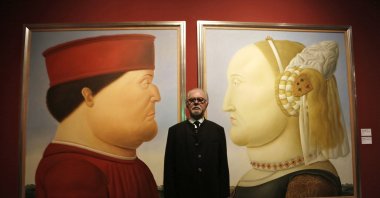 Colombian artist Fernando Botero poses for photos in front of his paintings titled &quot;After Piero Della Francesca&quot; before the opening of his exhibition at the National Museum in Beijing, China, Nov. 20, 2015. (EPA Photo)