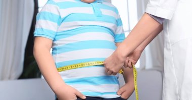 An obese child may encounter mocking and exclusion from friends and thus have adaptation issues on a daily basis. (Shutterstock Photo)